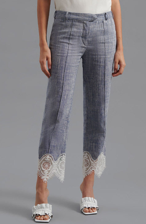 The VINCE is a tailored linen pant enhanced with transparent embroidered lace found along the bottom of the leg. The VINCE is enhanced with a cropped hem and fixed pleating placed along the front center of the pant leg ensuring a seamless silhouette.