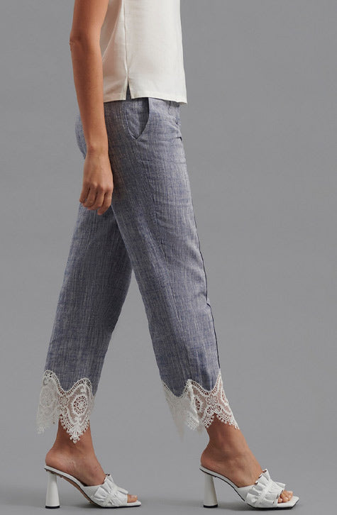 The VINCE is a tailored linen pant enhanced with transparent embroidered lace found along the bottom of the leg. The VINCE is enhanced with a cropped hem and fixed pleating placed along the front center of the pant leg ensuring a seamless silhouette.