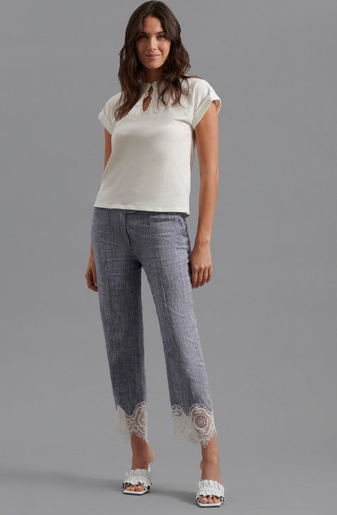 The VINCE is a tailored linen pant enhanced with transparent embroidered lace found along the bottom of the leg. The VINCE is enhanced with a cropped hem and fixed pleating placed along the front center of the pant leg ensuring a seamless silhouette.