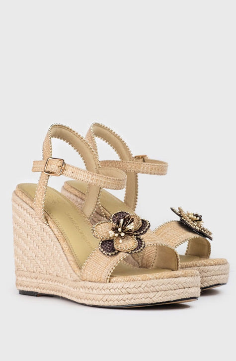 The ONECA sandal is a wedge platform and heel in jute, enhanced with a delicate flower detail along the toe straps. An ankle strap completes the look of this ultra-chic sandal. 