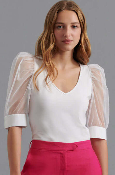 The AERIAL is a  pima cotton top enhanced with voluminous sleeves crafted from a sheer mesh fabric and featuring an elegant V-neckline. The AERIAL is both refined and understated making it a perfect addition to your wardrobe to wear to the office and for evening events.