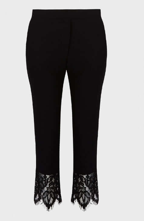 The GABI are ankle length black crepe pants enhanced with a wide delicate eyelash scalloped black lace along the hem of each pant leg. These ankle length pants feature a center-front zipper with a hook and eye for closure and Italian side pockets.