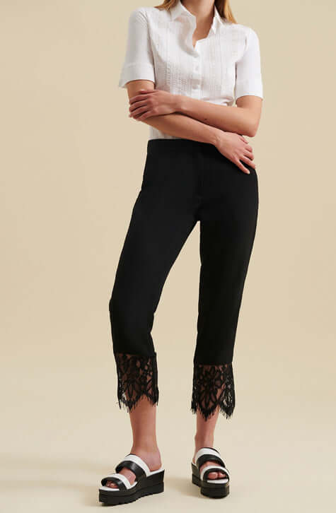 The GABI are ankle length black crepe pants enhanced with a wide delicate eyelash scalloped black lace along the hem of each pant leg. These ankle length pants feature a center-front zipper with a hook and eye for closure and Italian side pockets.